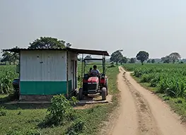 Porta Cabin near a partially built structure with exposed rebar in India.