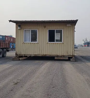 Porta Cabin at an Indian building site with bamboo scaffolding.